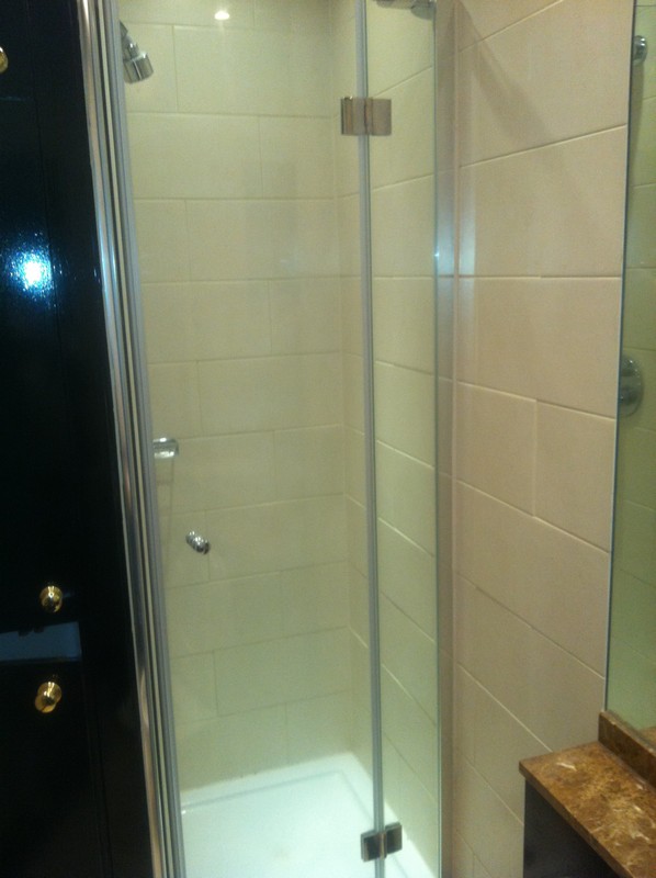 Frameless glass shower enclosure with chrome fittings in Golders Green