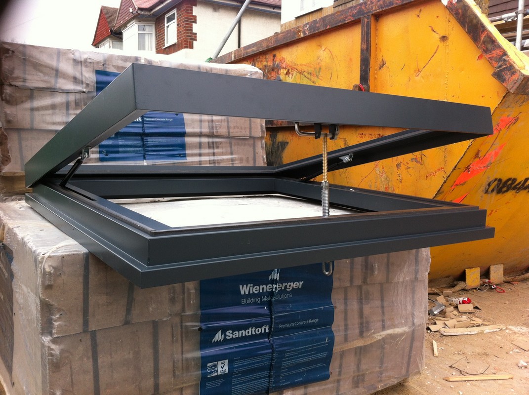Opening flat roof skylight in anthracite grey installed in Golders Green