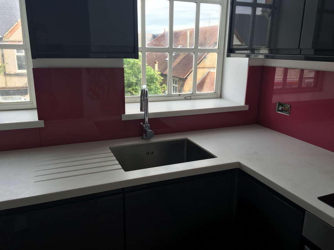 Deep plum coloured glass splashback in modern Golders Green kitchen