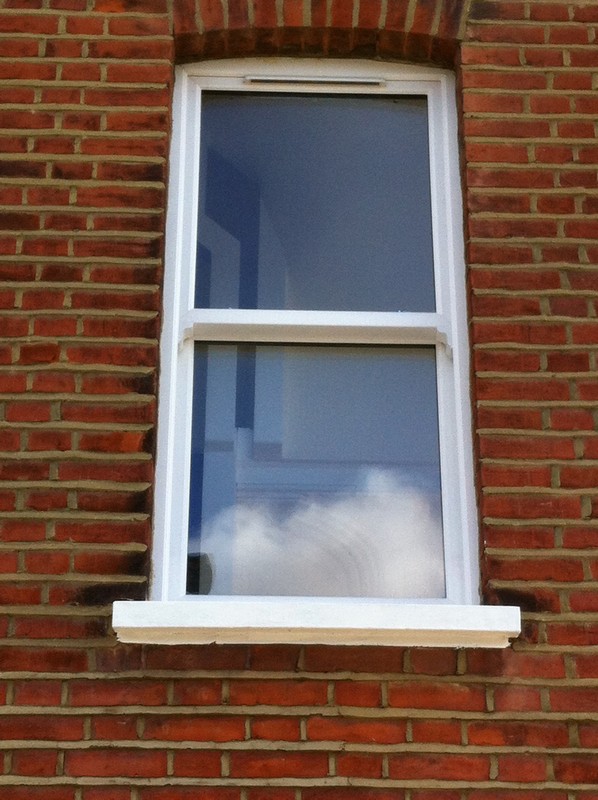uPVC sash window on Victorian red brick house in Golders Green